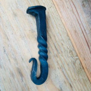 Handcrafted bottle opener made from an upcycled railroad spike, showcasing rustic charm and sustainable craftsmanship