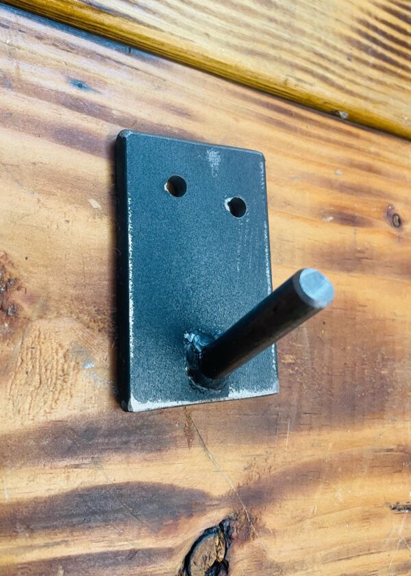 Steel sturdy wall hook mounted on a wooden board, suitable for hanging coats and hats.