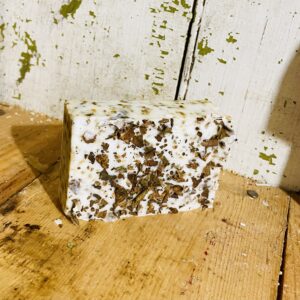 A bar of tobacco anti-aging soap, displayed against a neutral background.
