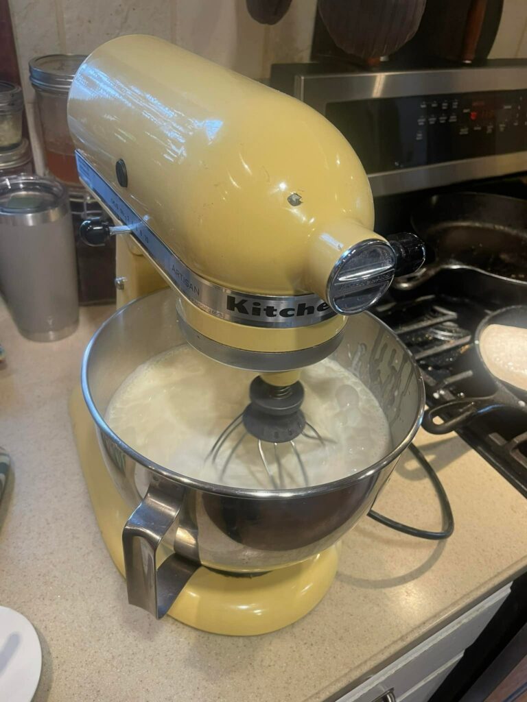 Capturing a delightful moment in the kitchen as the KitchenAid Stand Mixer transforms heavy cream into rich and creamy butter. The whisk attachment whirs effortlessly, churning the cream until it separates into velvety butter and buttermilk, showcasing the mixer's versatility and culinary magic. #KitchenAidMagic #ButterMaking #CreamyDelights #WhiskingWonders