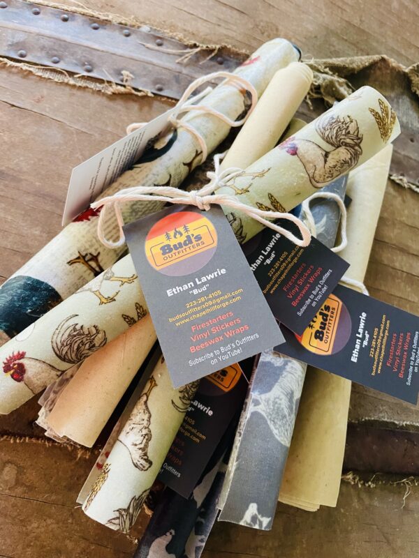 Beeswax wraps laid out on a wooden surface, showcasing their natural texture and various sizes, made from local beeswax, cotton fabric, jojoba oil, and pine tar resin.