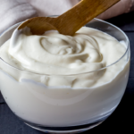 "Freshly made homemade yogurt in a bowl, embodying the creamy richness of from-scratch goodness, ideal for homesteading moms."