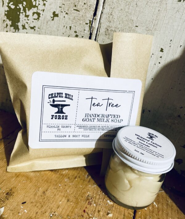 Two skincare products for natural acne care set: a bar of acne soap with tea tree essential oil and a jar of lavender whipped tallow balm.