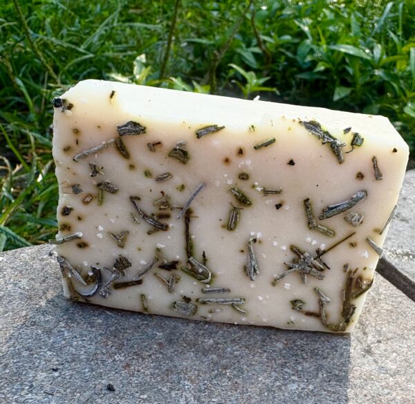 Creamy goat milk soap bar topped with dried lavender buds, handmade with natural ingredients