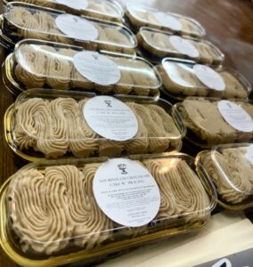 Several mini sourdough chocolate cakes topped with creamy peanut butter icing, displayed on a bakery tray — made from our long-fermented recipe designed for bulk microbakery baking.